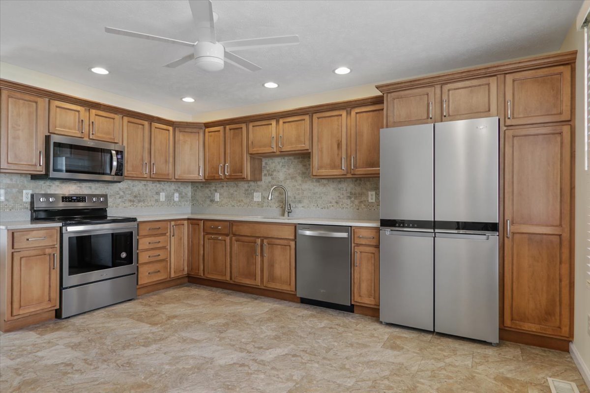 1707 Sunrise Point Normal, IL 61761 - Photo 13 of 23 a kitchen with granite countertop a refrigerator stove and microwave