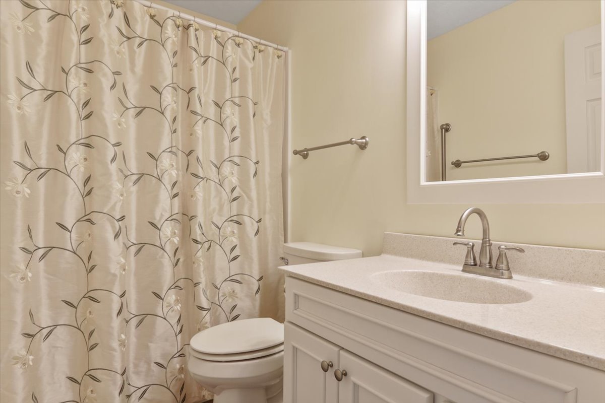 1707 Sunrise Point Normal, IL 61761 - Photo 18 of 23 a bathroom with a granite countertop toilet a sink a mirror and a shower curtain
