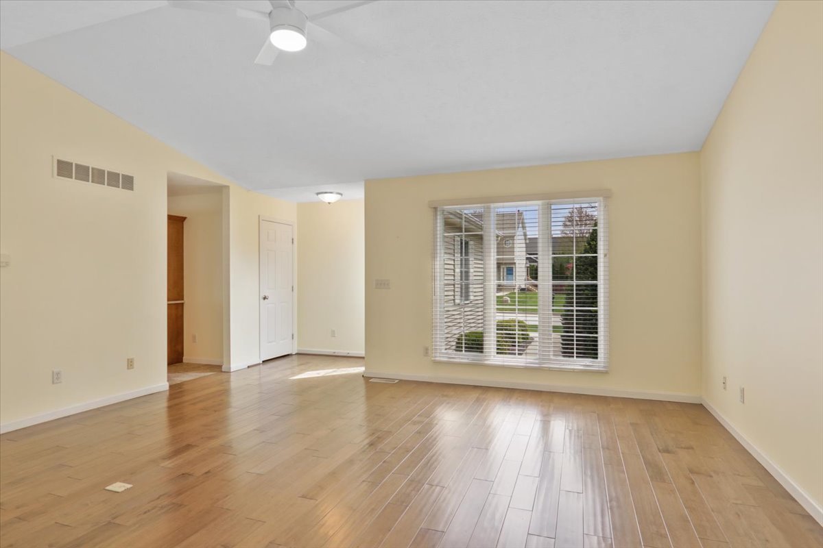 1707 Sunrise Point Normal, IL 61761 - Photo 9 of 23 an empty room with wooden floor and windows