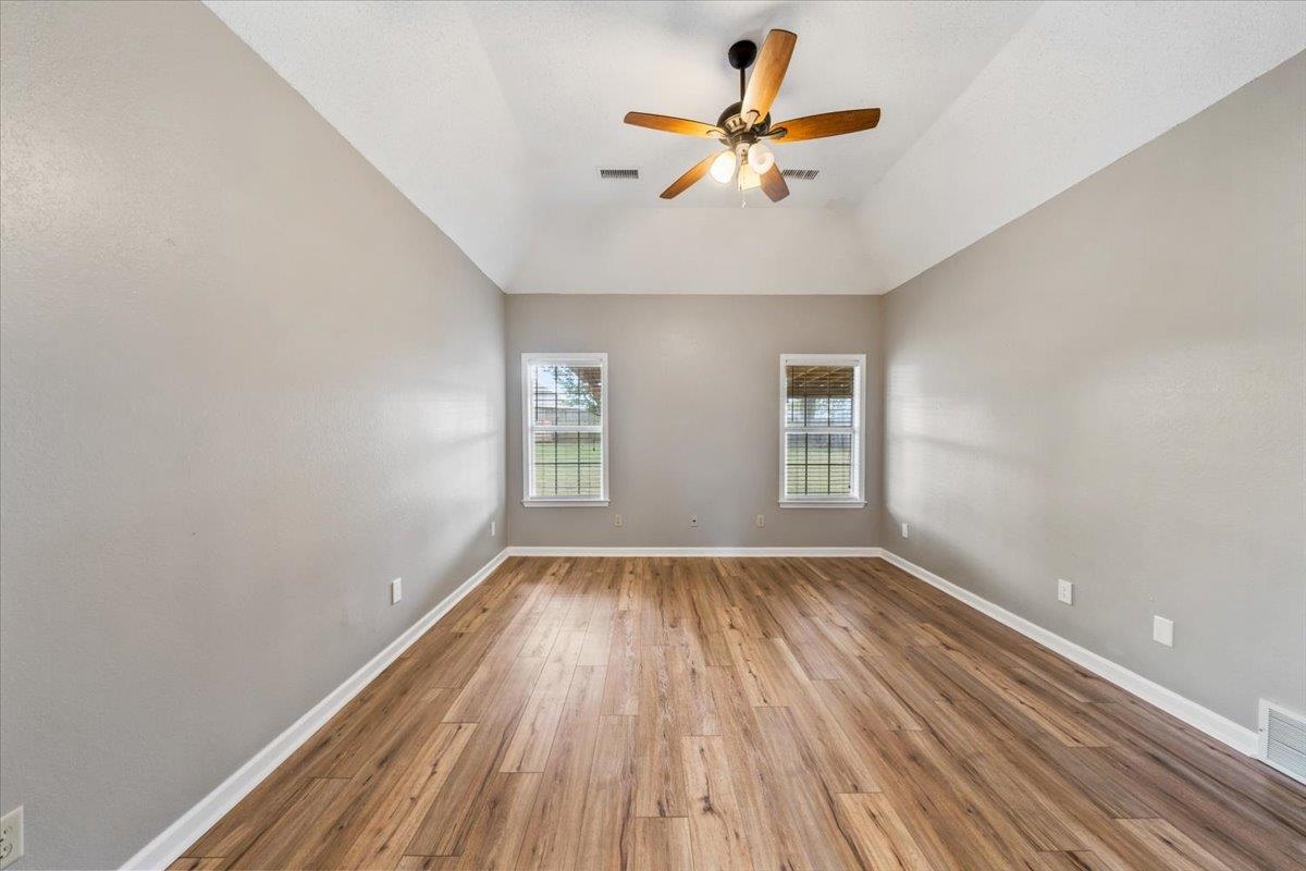 1279 River Ridge Drive Collierville, TN 38017 - Photo 11 of 28 an empty room with wooden floor and windows