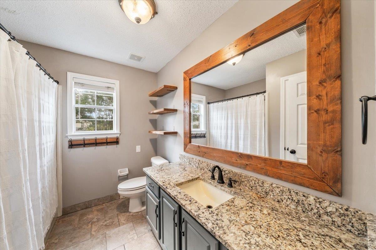 1279 River Ridge Drive Collierville, TN 38017 - Photo 16 of 28 a bathroom with a granite countertop sink and a mirror