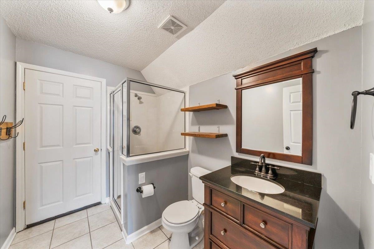 1279 River Ridge Drive Collierville, TN 38017 - Photo 19 of 28 a bathroom with a granite countertop sink toilet mirror and shower