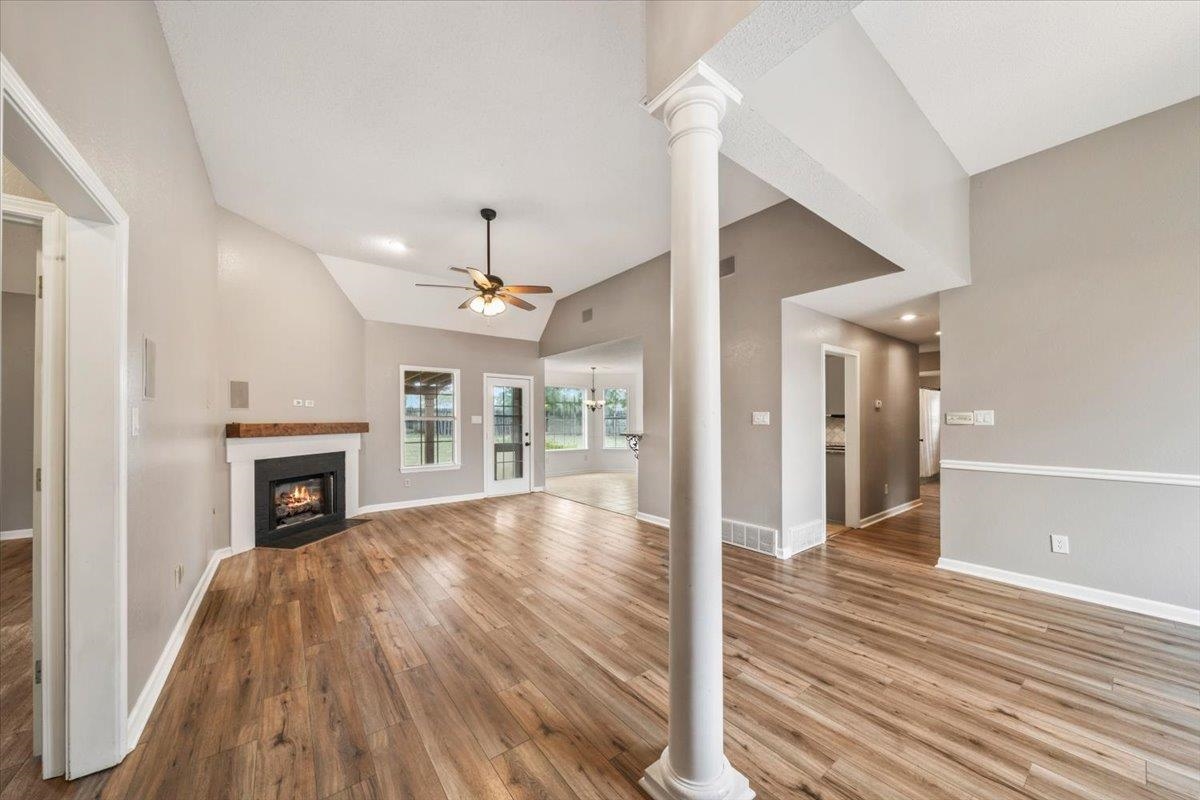 1279 River Ridge Drive Collierville, TN 38017 - Photo 4 of 28 a view of a livingroom with wooden floor a ceiling fan and kitchen space