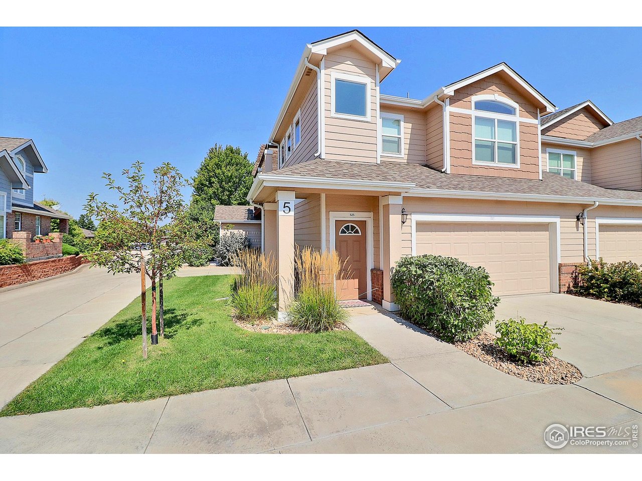 4672 West 20th Road, Unit 525 Greeley, CO 80634 - Photo 1 of 35 a front view of a house with a yard and trees