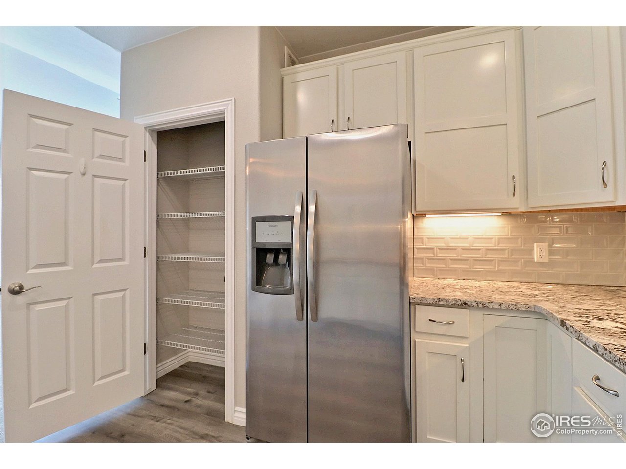 4672 West 20th Road, Unit 525 Greeley, CO 80634 - Photo 14 of 35 a kitchen with cabinets and a refrigerator