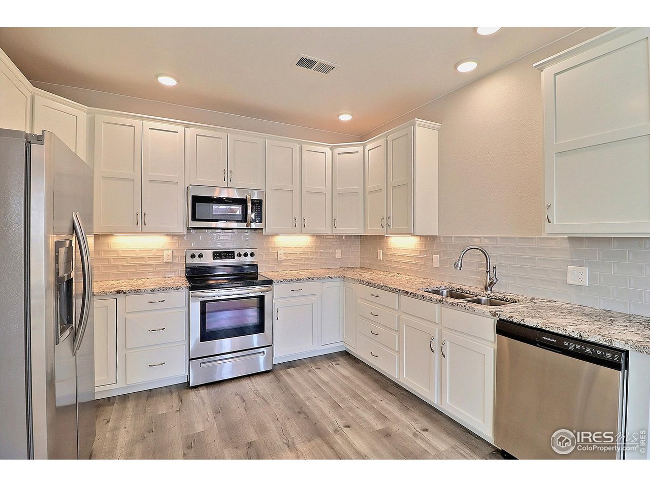 4672 West 20th Road, Unit 525 Greeley, CO 80634 - Photo 17 of 35 a kitchen with stainless steel appliances granite countertop a sink a stove a refrigerator and cabinets