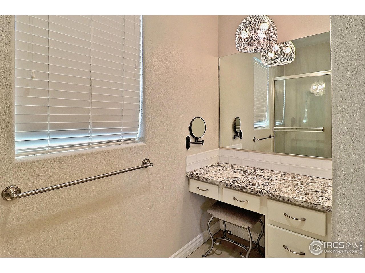 4672 West 20th Road, Unit 525 Greeley, CO 80634 - Photo 24 of 35 a bathroom with a sink a vanity and a mirror