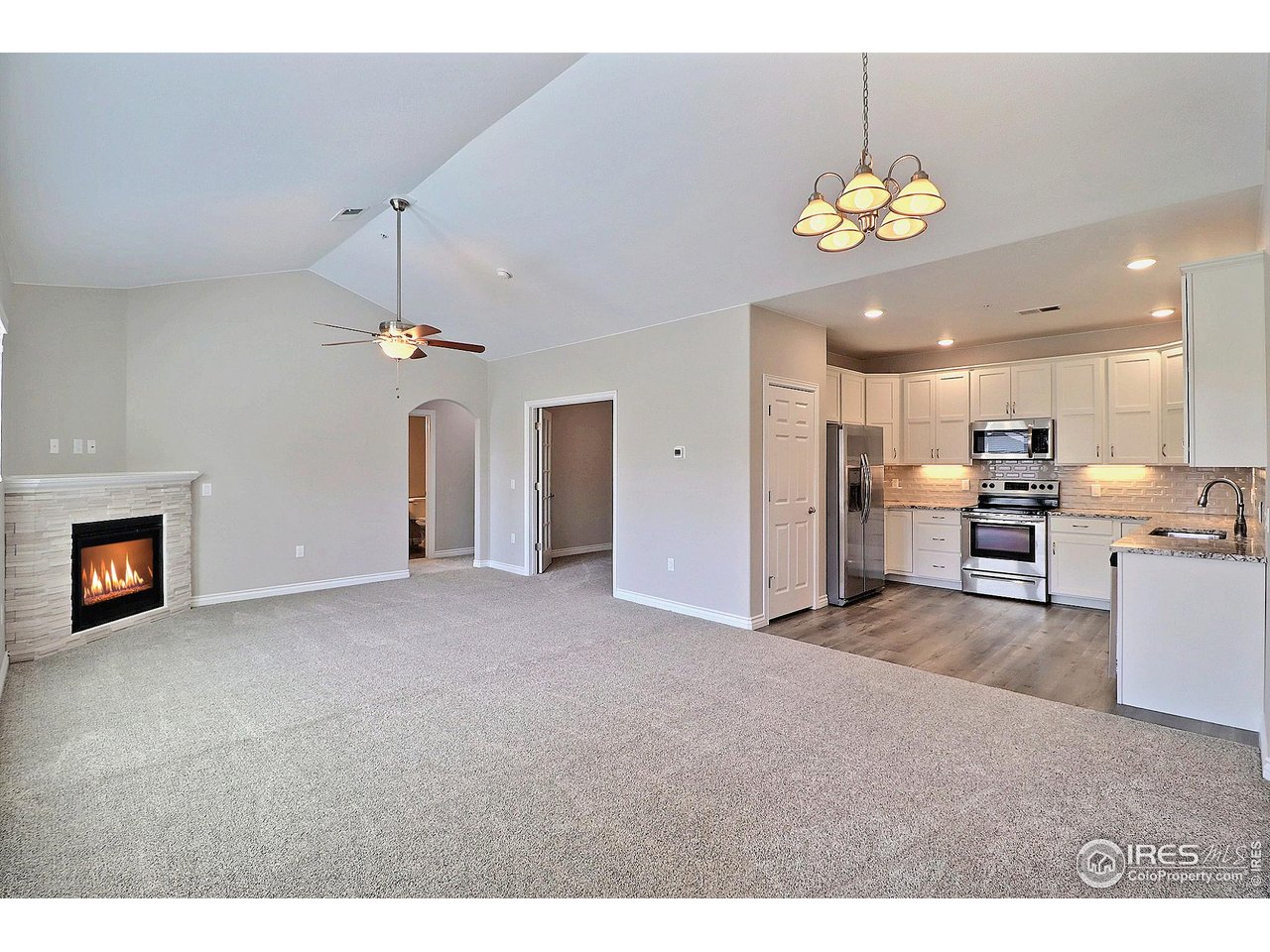 4672 West 20th Road, Unit 525 Greeley, CO 80634 - Photo 5 of 35 a view of a kitchen and a chandelier fire place