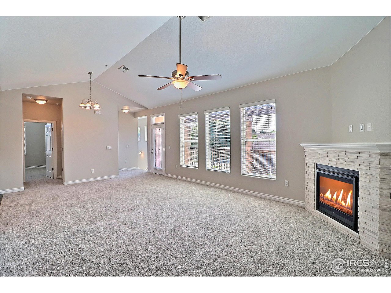 4672 West 20th Road, Unit 525 Greeley, CO 80634 - Photo 8 of 35 a view of an empty room with a fireplace and a window