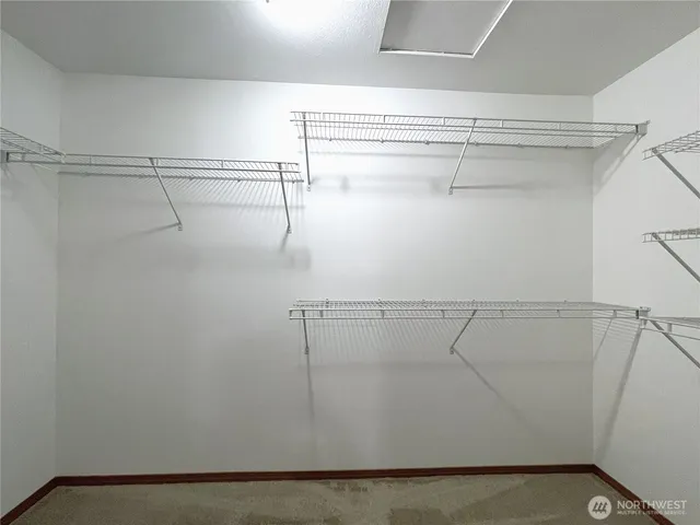 a en suite bathroom with a granite countertop sink and a mirror