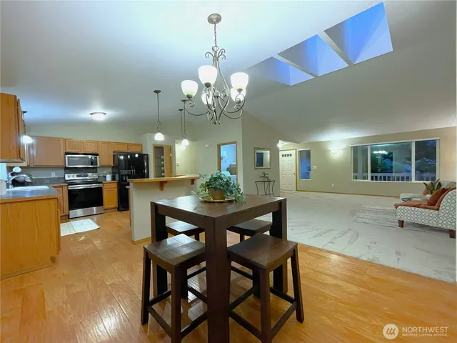 a view of a dining room with furniture and chandelier