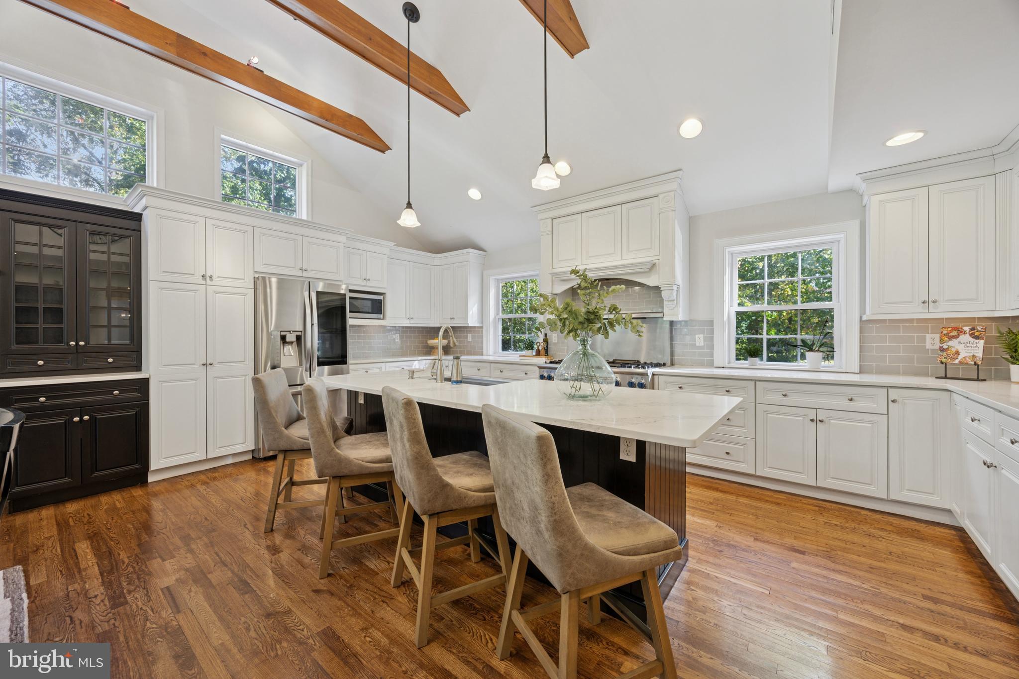 570 Fletcher Road Wayne, PA 19087 - Photo 30 of 54 a kitchen with stainless steel appliances a dining table chairs stove and refrigerator