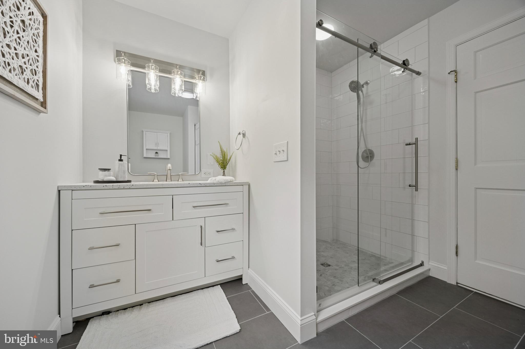 570 Fletcher Road Wayne, PA 19087 - Photo 41 of 54 a bathroom with a shower a sink and a mirror