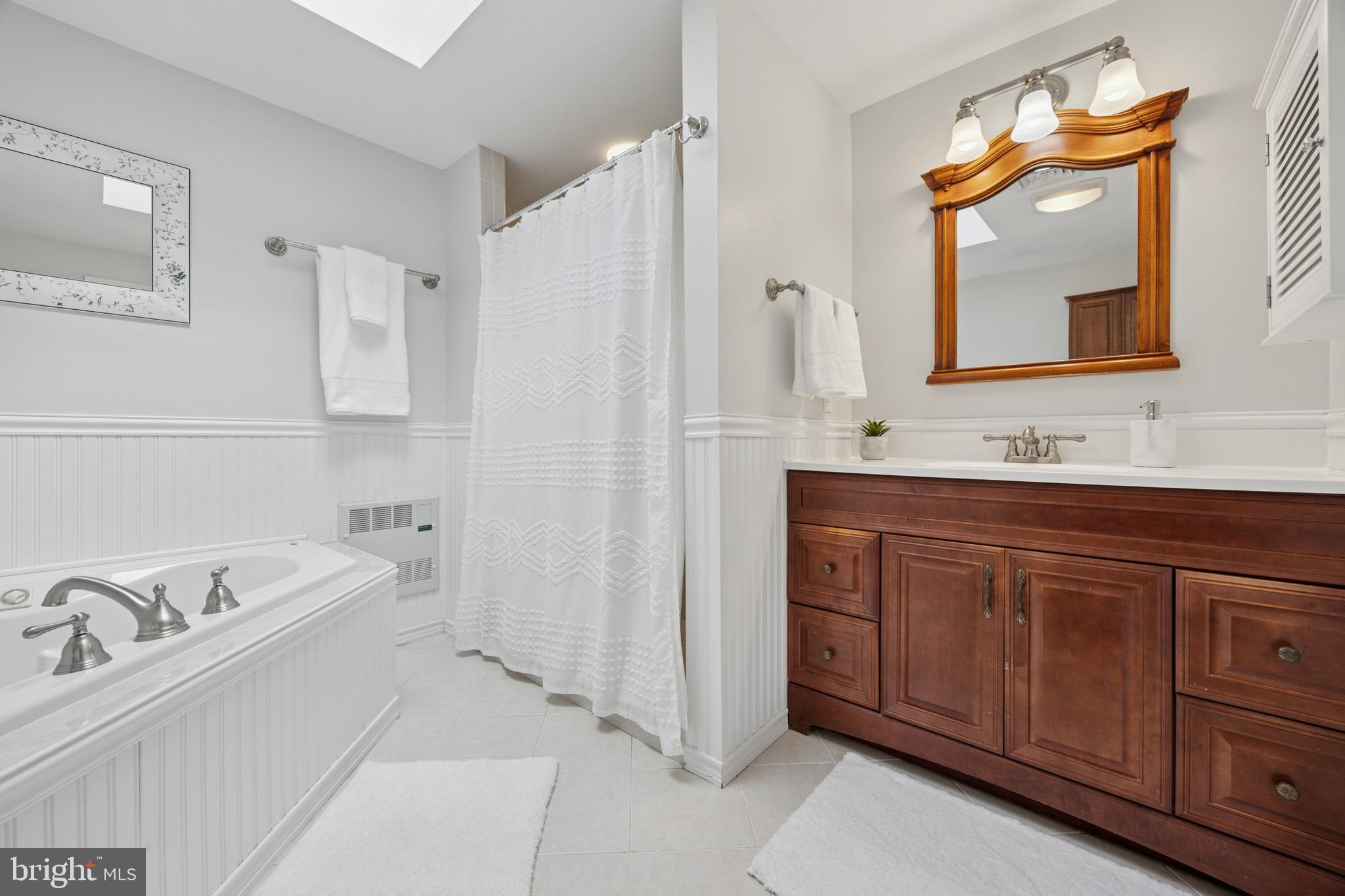 570 Fletcher Road Wayne, PA 19087 - Photo 42 of 54 a bathroom with a double vanity sink mirror and bathtub