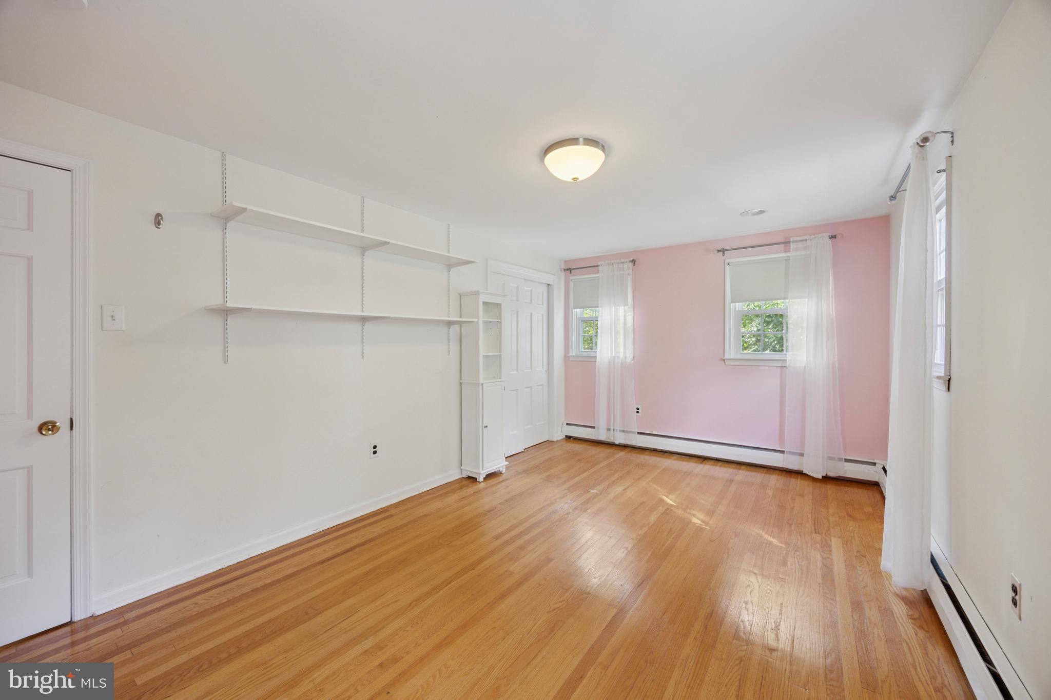 570 Fletcher Road Wayne, PA 19087 - Photo 46 of 54 an empty room with wooden floor and windows