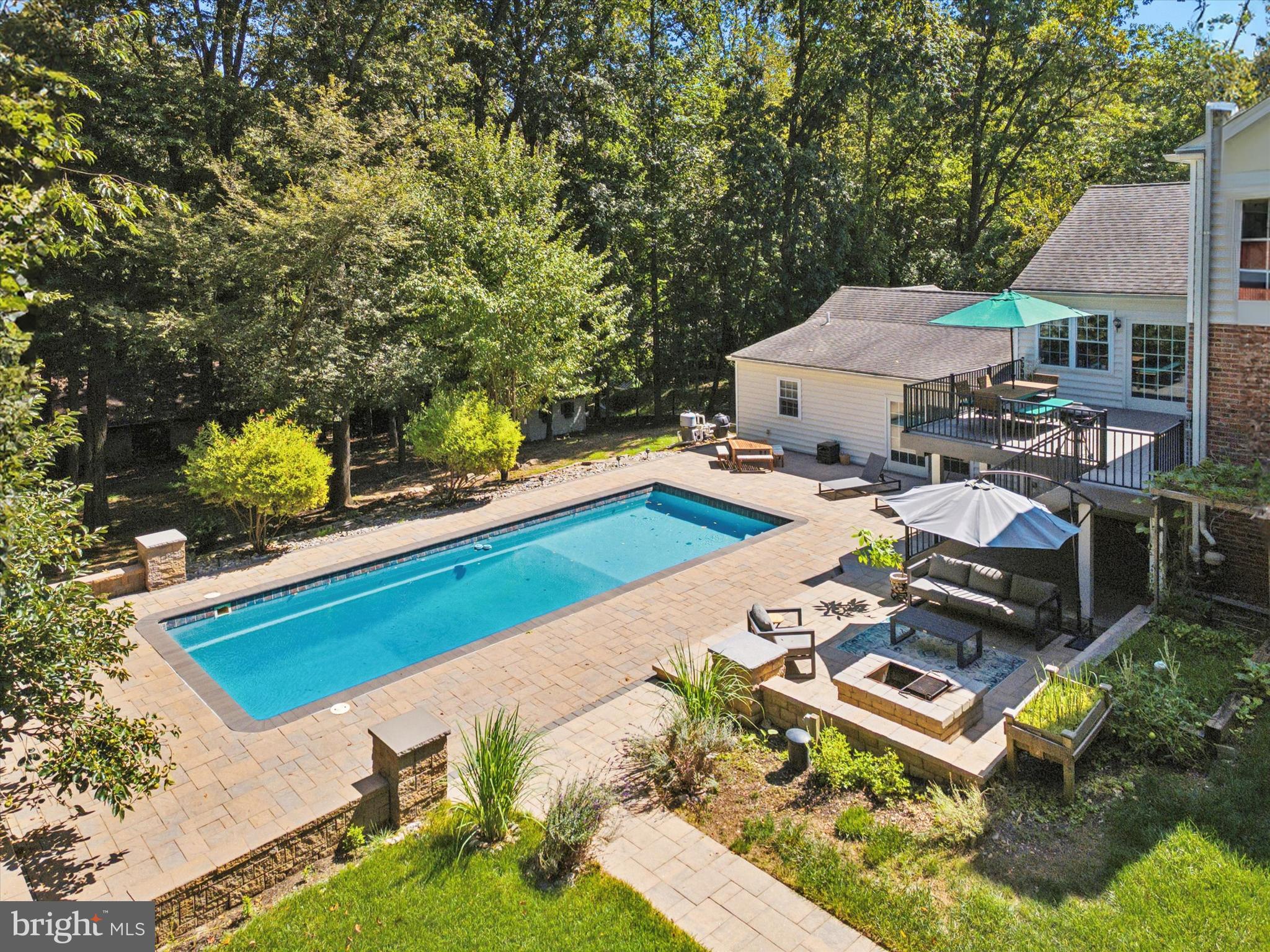 570 Fletcher Road Wayne, PA 19087 - Photo 5 of 54 an aerial view of a house with swimming pool and lake view