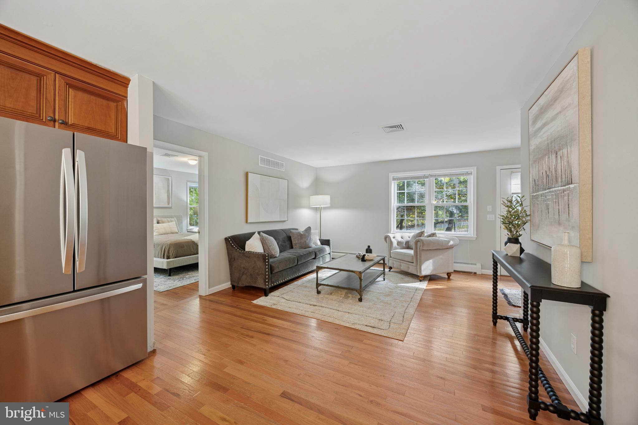 570 Fletcher Road Wayne, PA 19087 - Photo 52 of 54 a living room with furniture wooden floor and a refrigerator