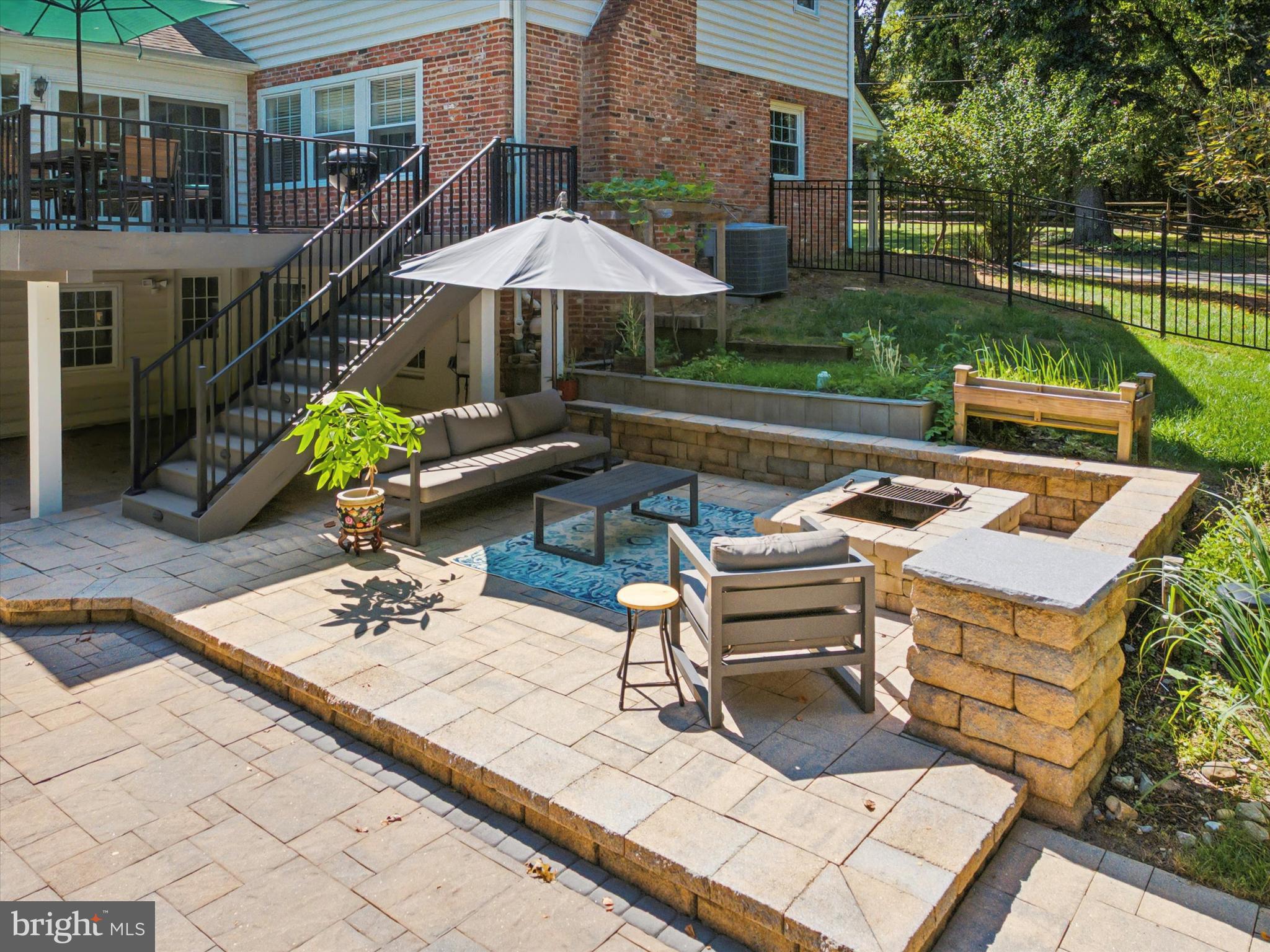 570 Fletcher Road Wayne, PA 19087 - Photo 6 of 54 a view of a patio with a table and chairs under an umbrella
