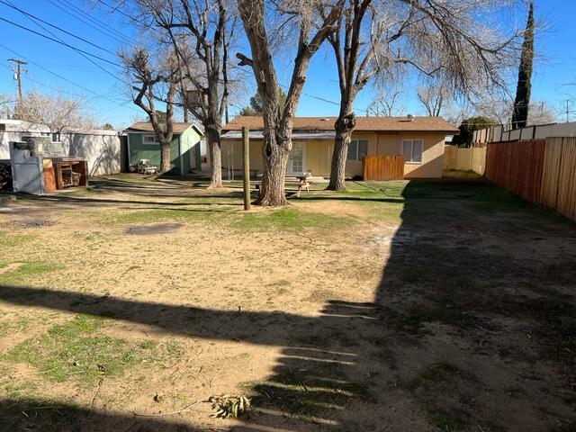 38879 Mesquite Road Palmdale, CA 93551 - Photo 11 of 12 a view of a yard with wooden fence