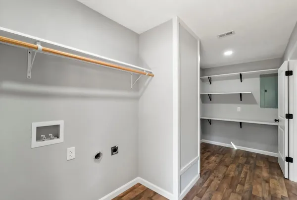 a view of walk in closet with empty racks