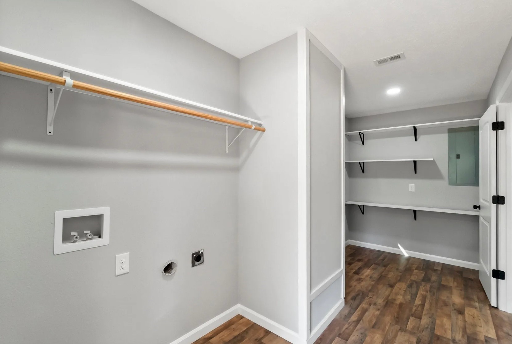 749 County Road 774 Buna, TX 77612 - Photo 6 of 9 This spacious, modern laundry room features sleek shelving, ample hanging space, and stylish wood-looking flooring, promising a blend of functionality and elegance for effortless laundry days.