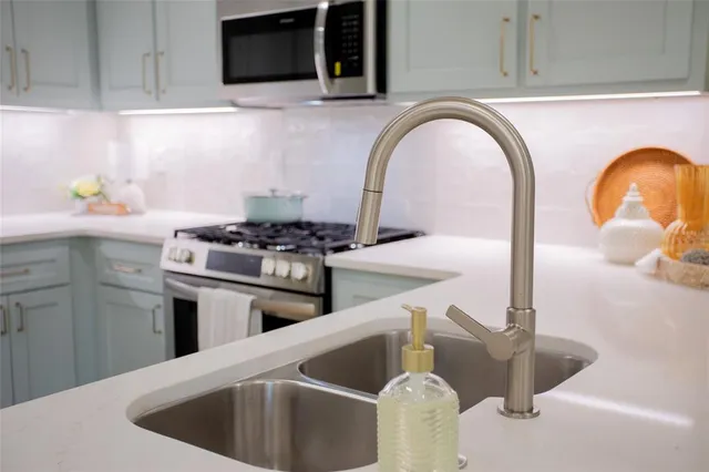 a kitchen with a stove a sink and a microwave