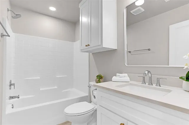 a bathroom with a sink a toilet and bathtub