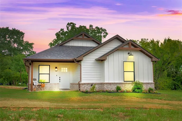 a view of a house with a swimming pool and a yard