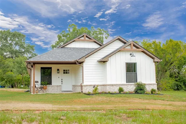 a front view of house with yard and green space