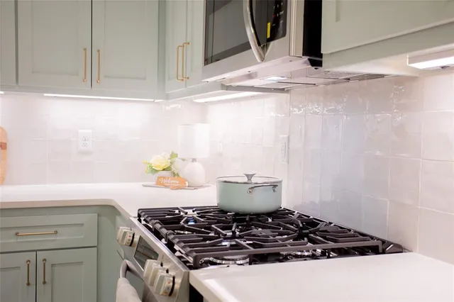 a stove top oven sitting inside of a kitchen
