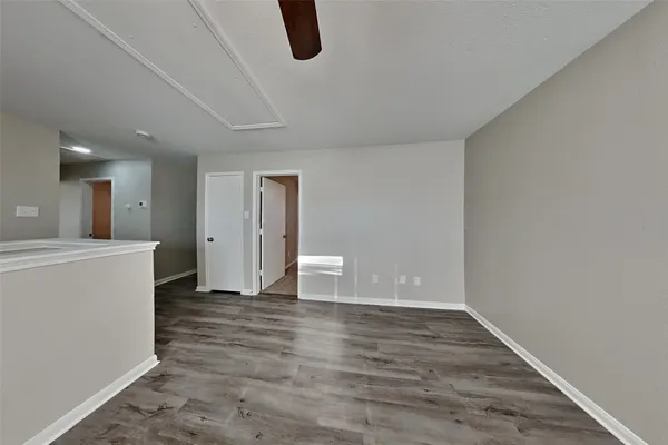 a view of a room with wooden floor and white walls