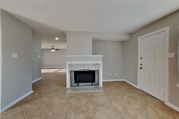 a view of an empty room with a fireplace
