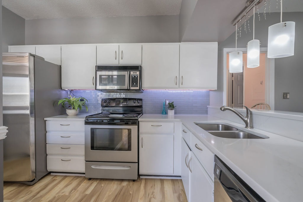 6020 Winterpointe Lane, Unit 201 Raleigh, NC 27606 - Photo 3 of 17 quartz countertops and subway tile backsplash keep this kitchen light and bright just like the rest of the house. Kitchen