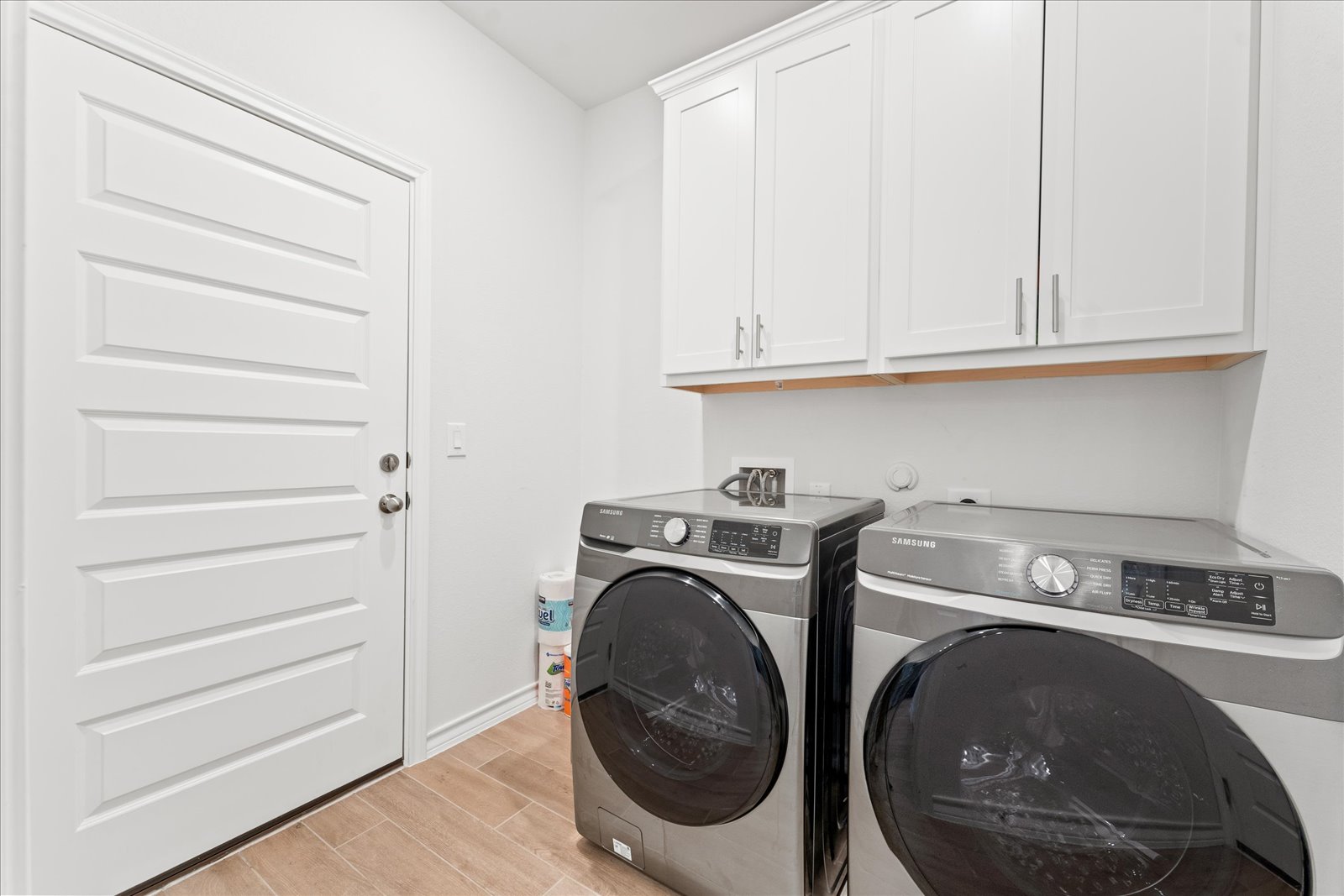 4607 Sweet Annie Path Austin, TX 78723 - Photo 12 of 29 Laundry area featuring wood finish floors, washer and clothes dryer, and cabinet space