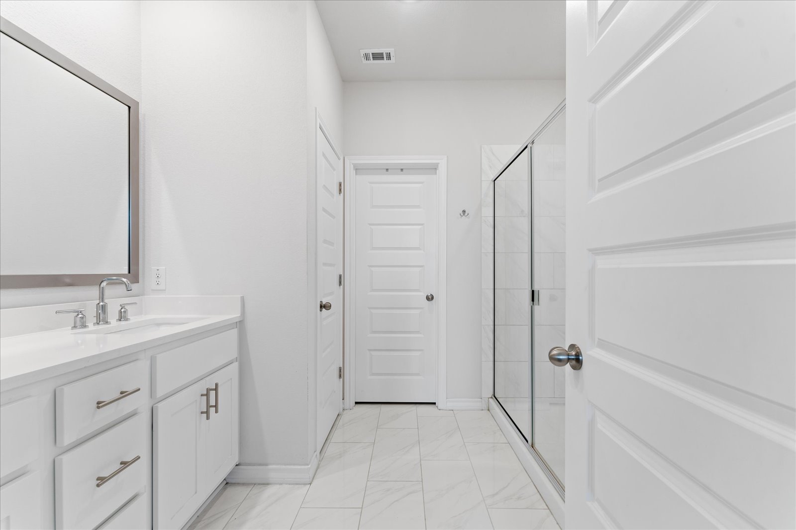 4607 Sweet Annie Path Austin, TX 78723 - Photo 15 of 29 Bathroom with a shower stall, double vanity, and light marble finish floors