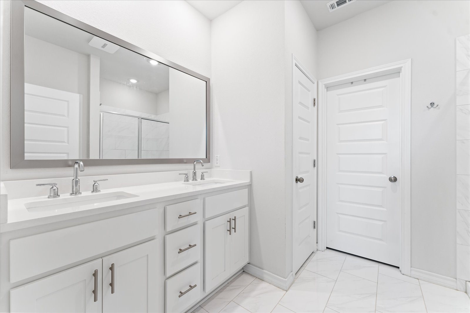4607 Sweet Annie Path Austin, TX 78723 - Photo 16 of 29 Bathroom with a shower stall, double vanity, and light marble finish floors