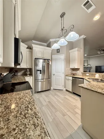a kitchen with stainless steel appliances a refrigerator sink and stove