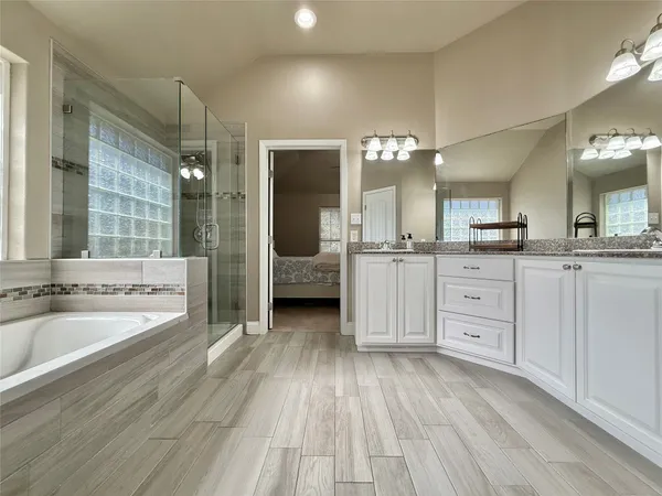 a large bathroom with a large tub and sink