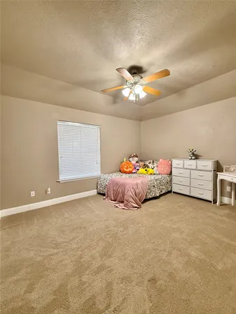a bed room with bed and a ceiling fan