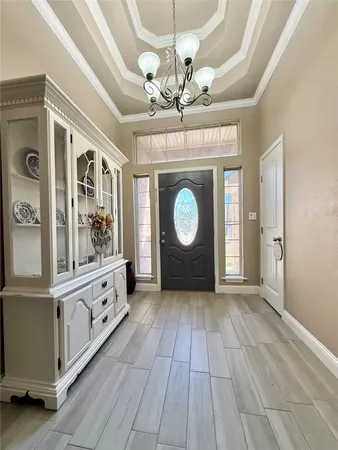 a view of a livingroom with wooden floor and chandelier