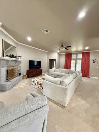 a spacious bedroom with a bed and a flat screen tv