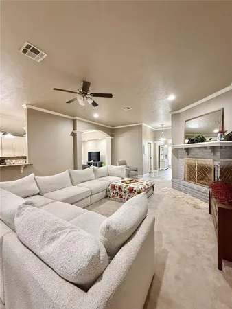 a living room with furniture and kitchen view
