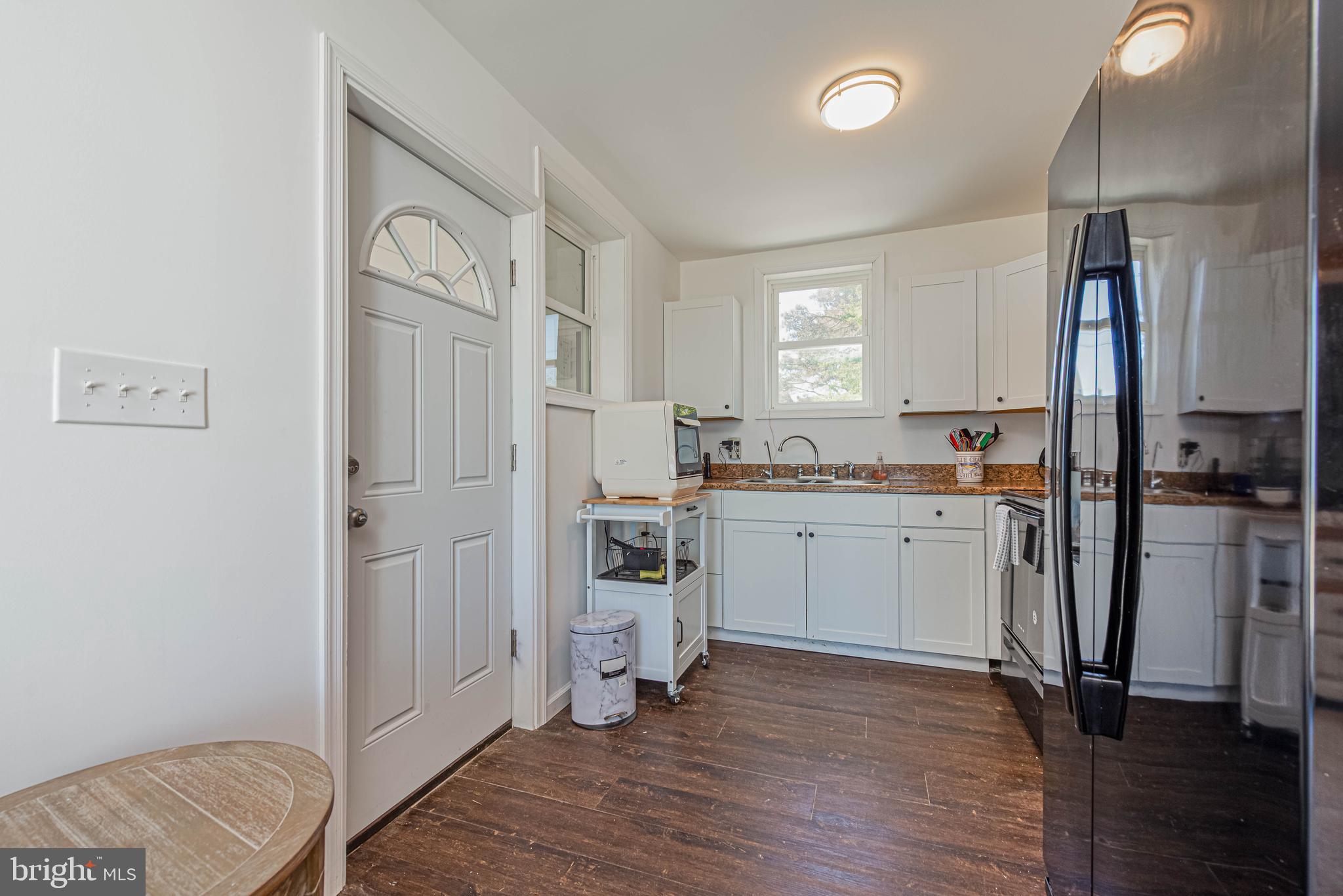11152 Roland Parks Road Deal Island, MD 21821 - Photo 17 of 42 a kitchen with white cabinets and wooden floor