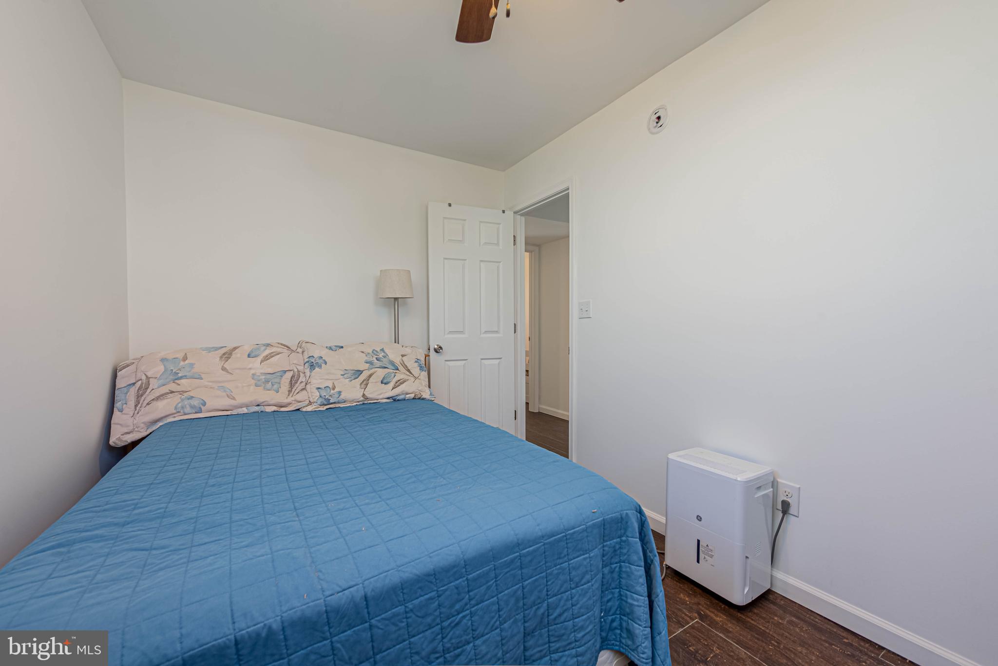 11152 Roland Parks Road Deal Island, MD 21821 - Photo 19 of 42 a bedroom with a bed and wooden floor