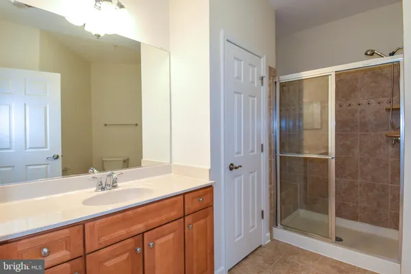 a bathroom with a shower sink and mirror