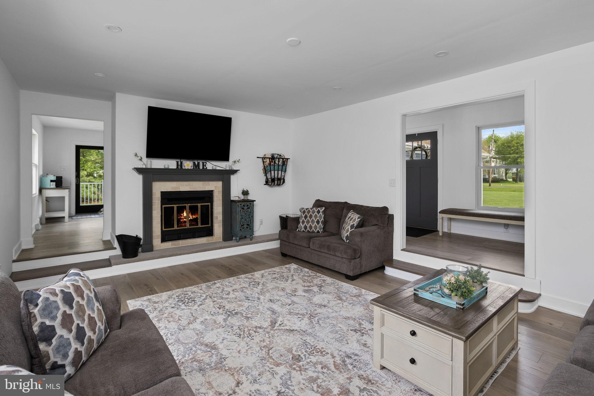 11 Bridge Road Lumberton, NJ 08048 - Photo 8 of 38 a living room with furniture a flat screen tv and a fireplace