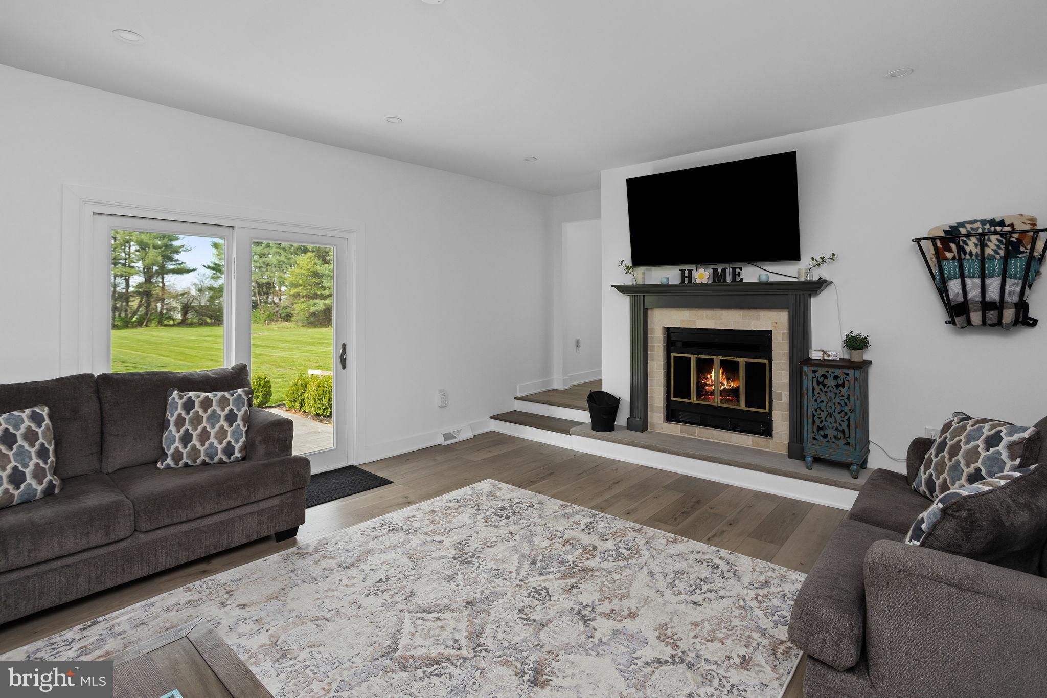 11 Bridge Road Lumberton, NJ 08048 - Photo 9 of 38 a living room with furniture a flat screen tv and a fireplace