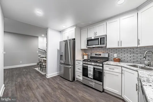 a kitchen with a refrigerator stove and microwave