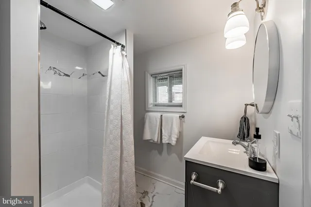 a bathroom with a sink and mirror