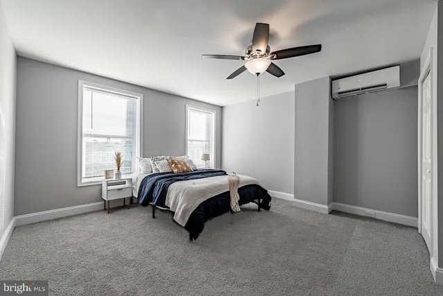 a spacious bedroom with a bed and window